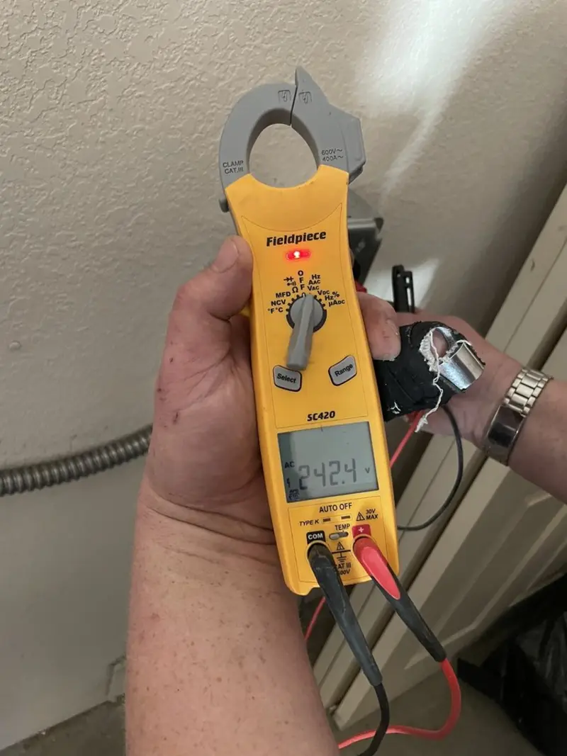 Voltage testing with clamp meter during Ceiling Fan Installation in Bemidji